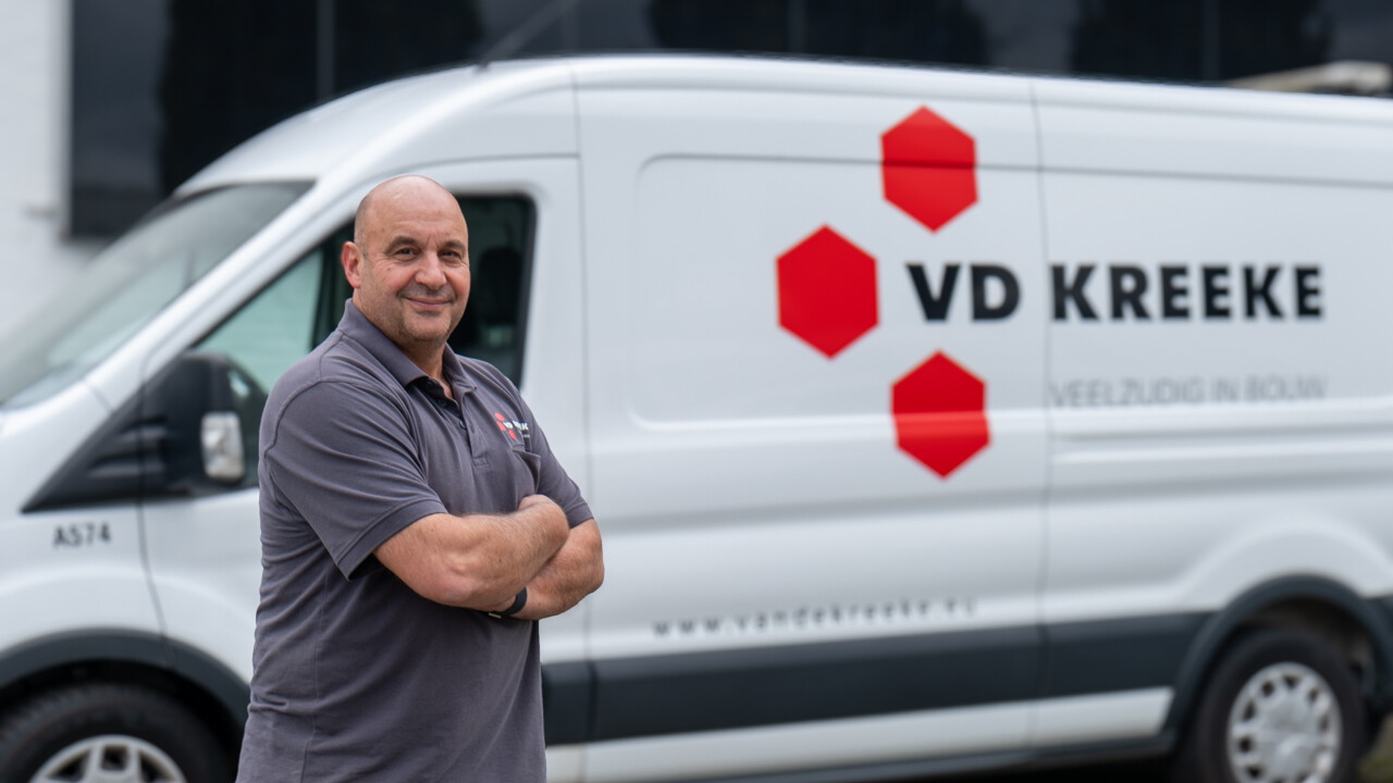 Michel Hofman, Head of Equipment at the Van de Kreeke Group, stands in front of a van with the Van De Kreeke logo.